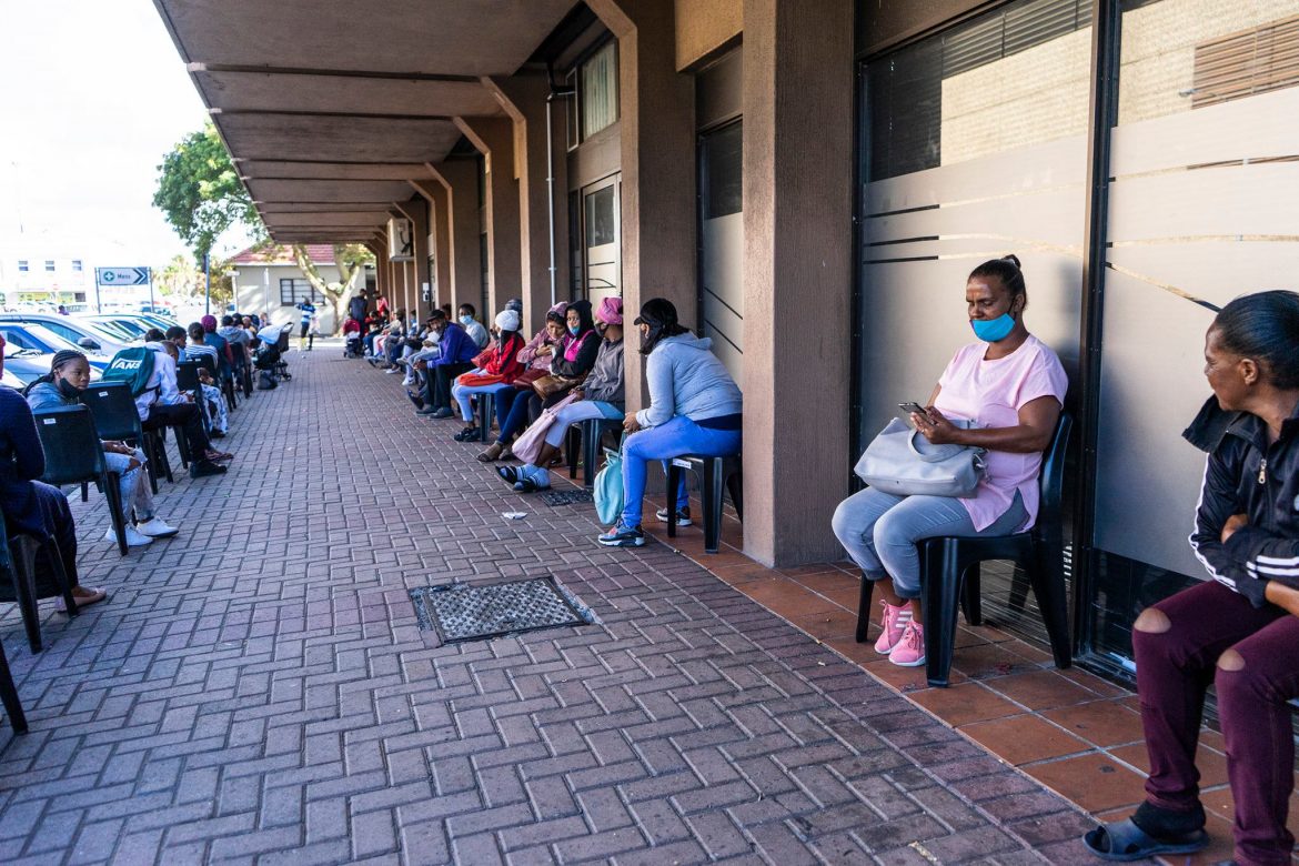 People waiting in line for their SASSA grant.