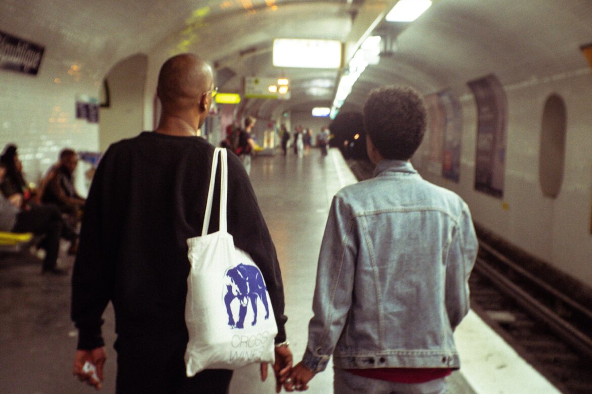 men carrying their partner's handbags