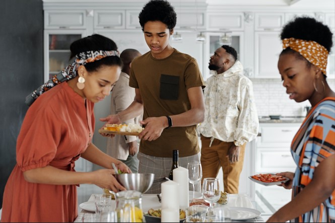 Woman preparing the table for dinner with her family