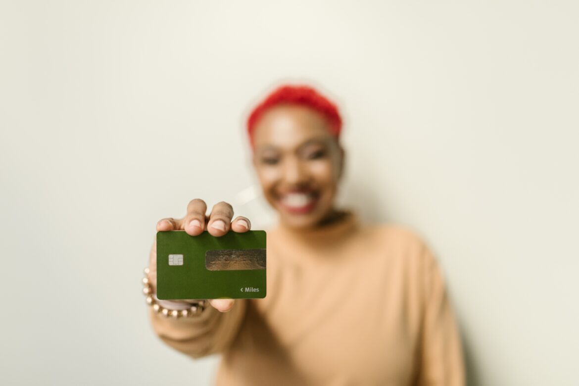 Woman holding a card/ Pexels