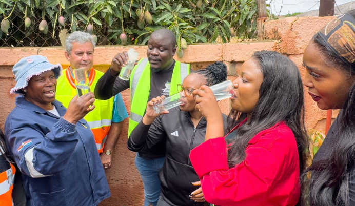 Government officials drinking water in Hammanskraal