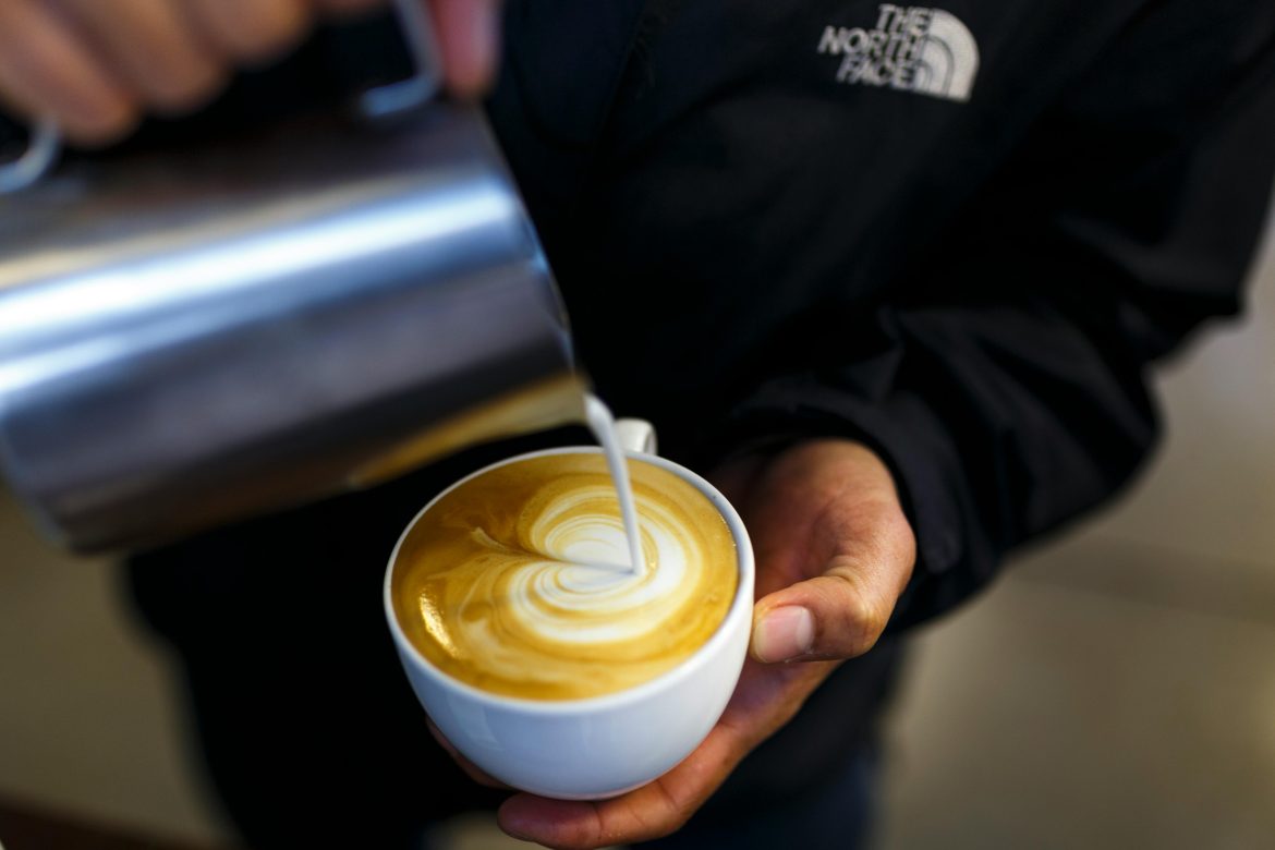 Barista preparing a cup of cappuccino